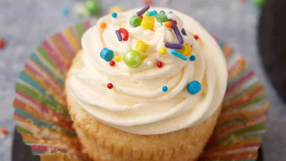 A single vanilla cupcake with the wrapper removed.