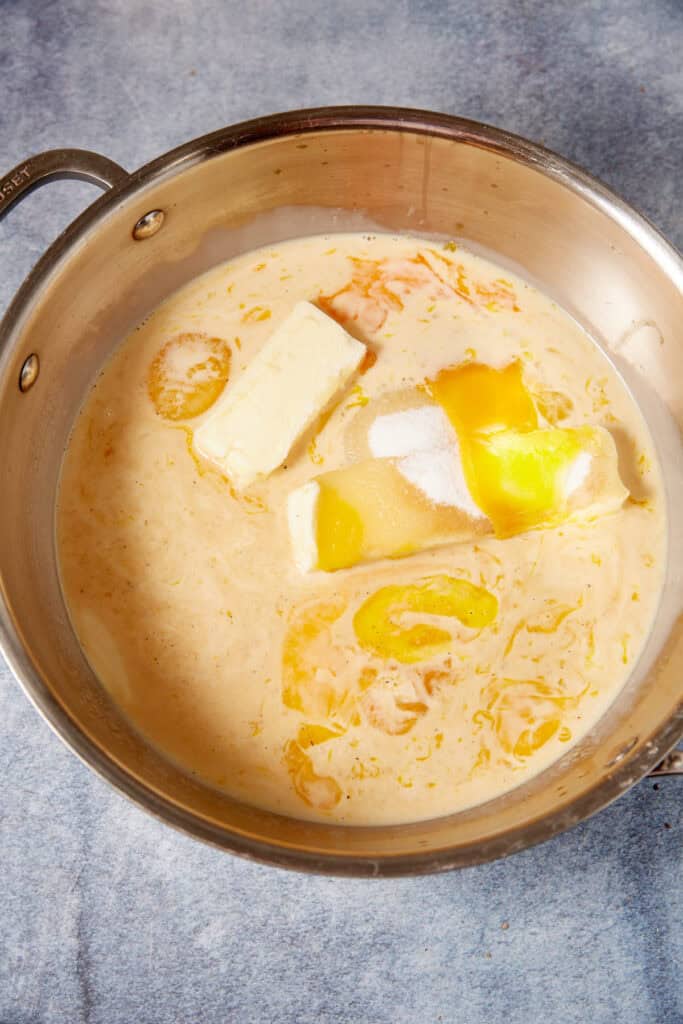 German chocolate cake filling ingredients in a saucepan before cooking, including evaporated milk, butter, sugar, and egg yolks.