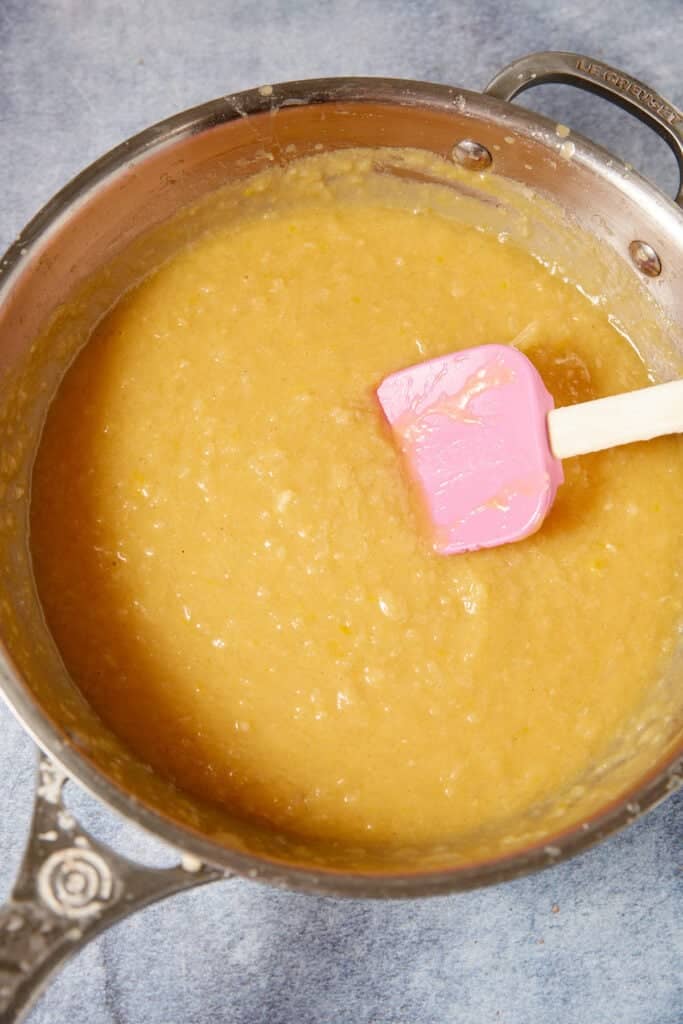 German chocolate cake filling cooking in a saucepan until thick and golden.