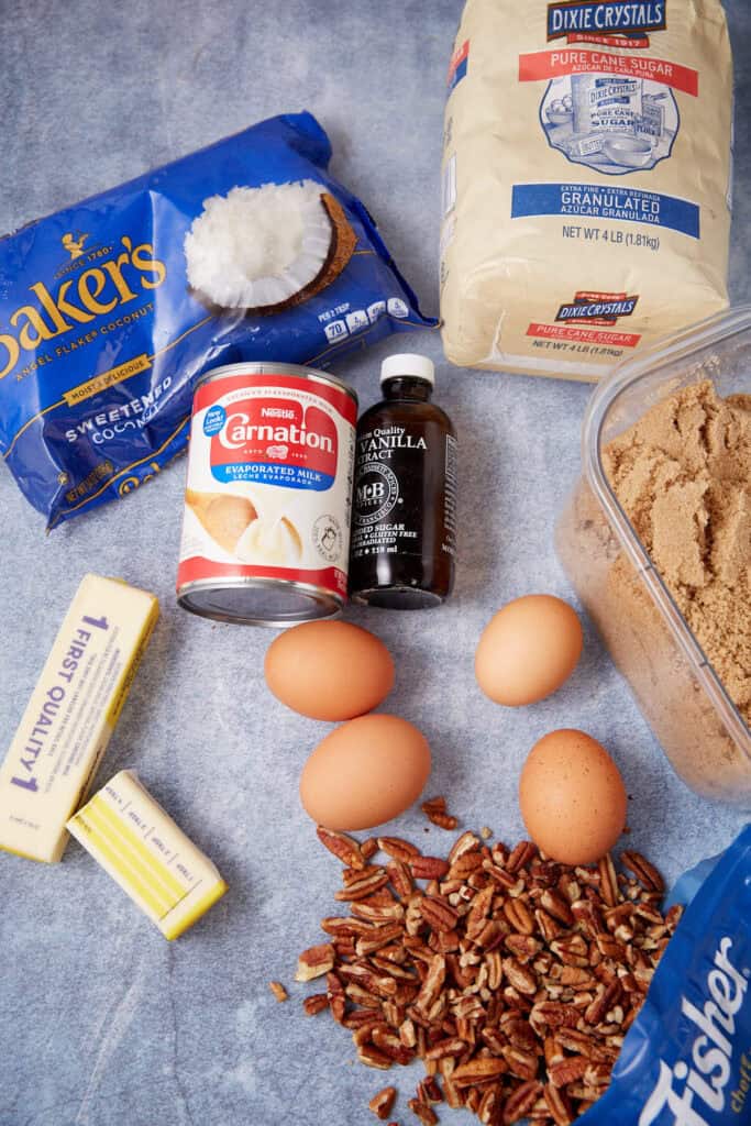 Cake batter in a mixing bowl with ground dry ingredients added on top and eggshells in the background.