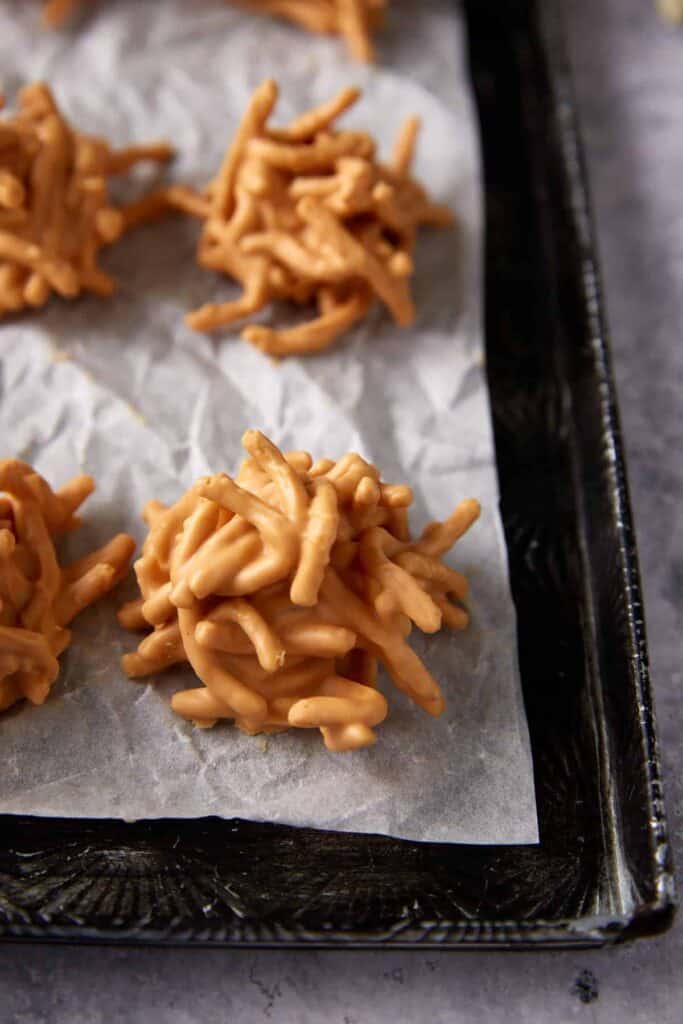 Close-up of a four ingredient haystack cookie on parchment paper.