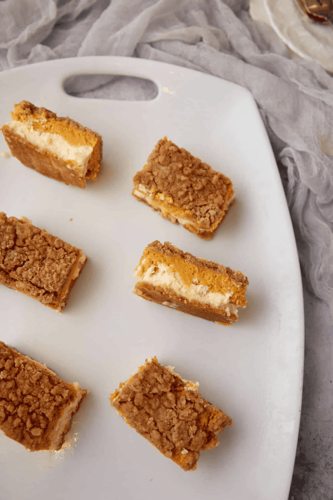 Pumpkin cheesecake bars on a platter.