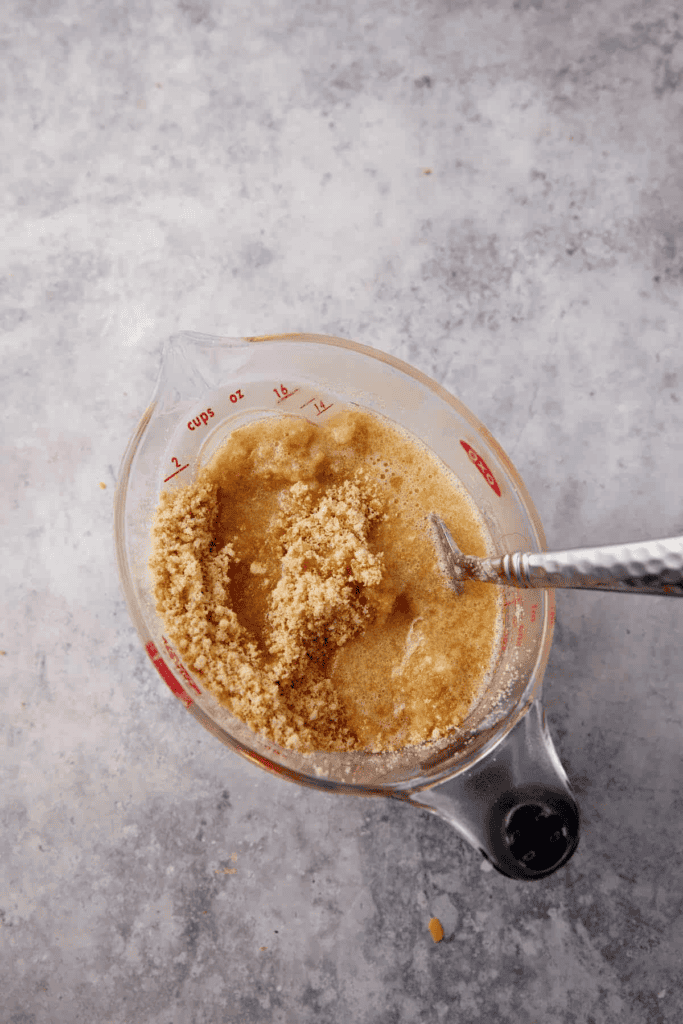 Butter and cookie crumbs in a measuring cup.