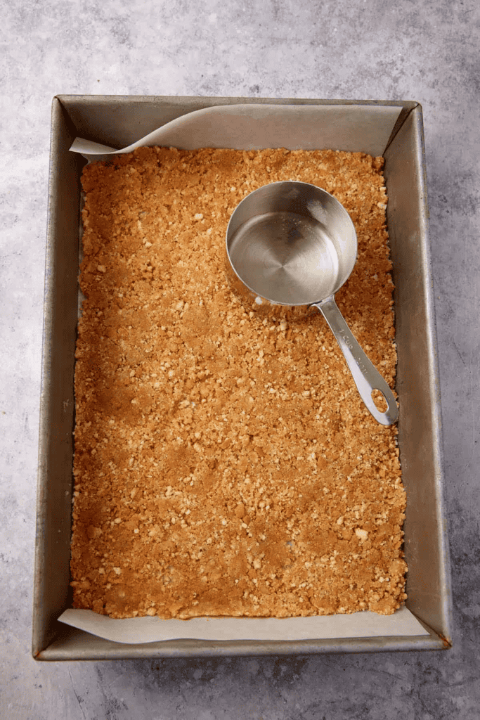 Vanilla wafer crust in a baking pan.