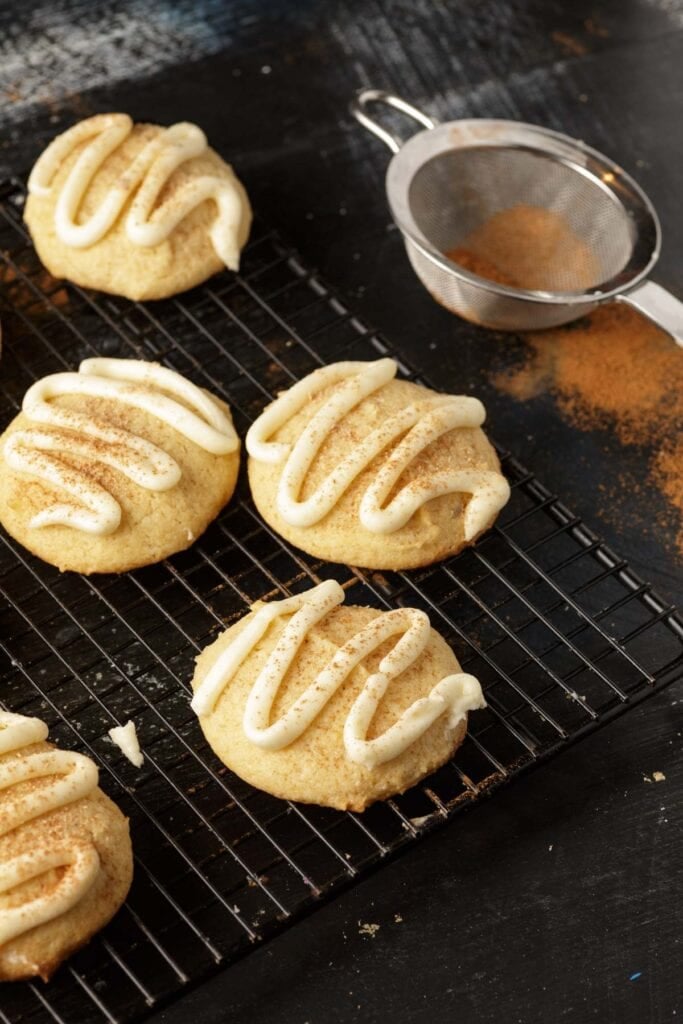 Frosting piped onto eggnog cookies.